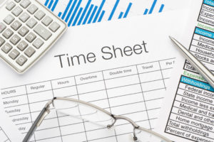 Feature image of an employee time sheet and a spreadsheet of payroll tax deductions